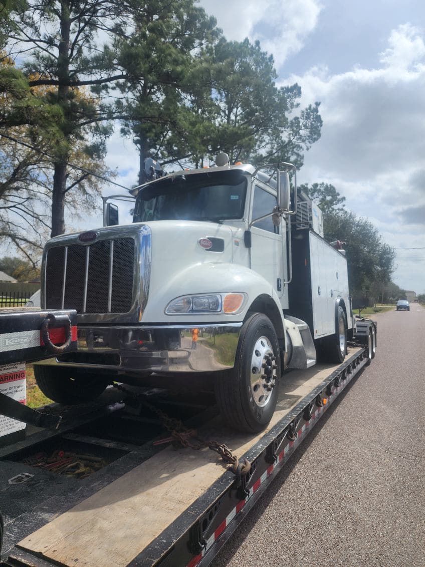 Truck loaded on a vehicle carrier for transport